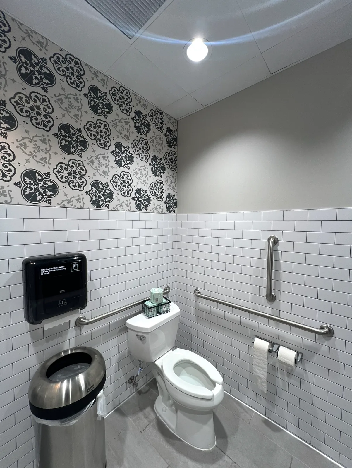 Bathroom with patterned tile and accessible fixtures