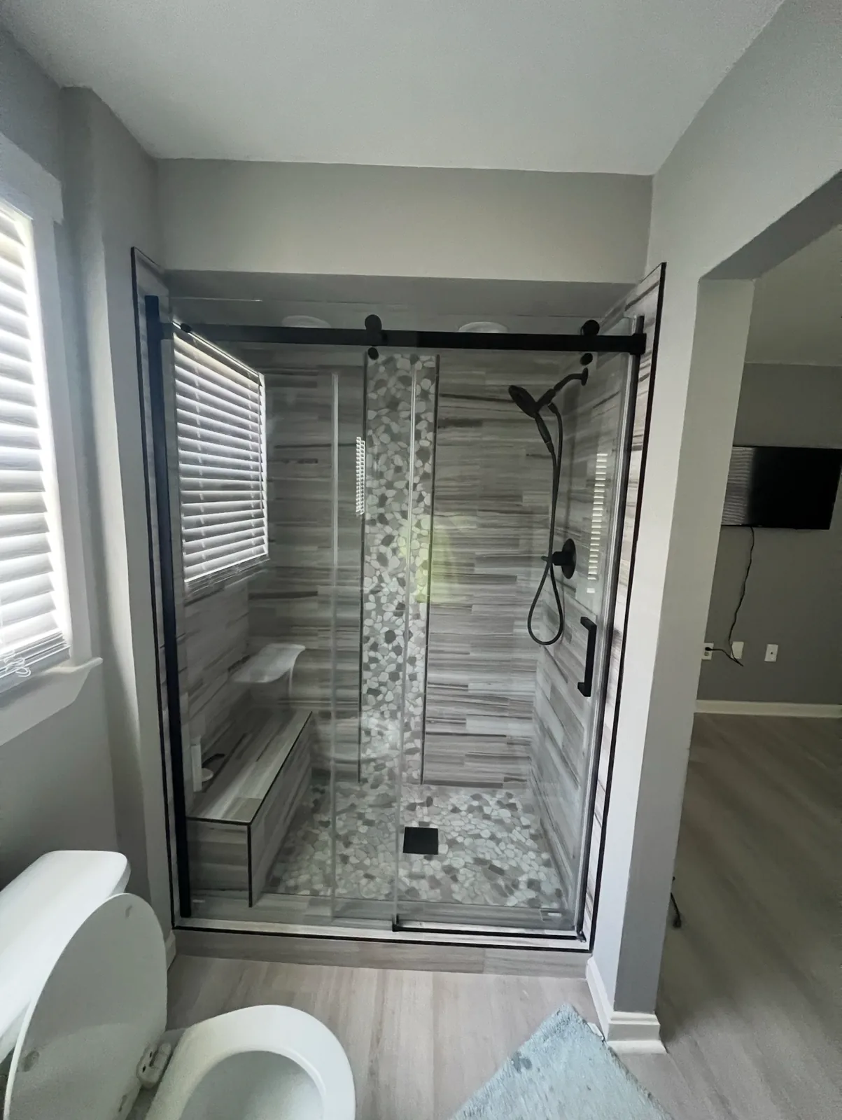 Finished tiled shower with a glass door